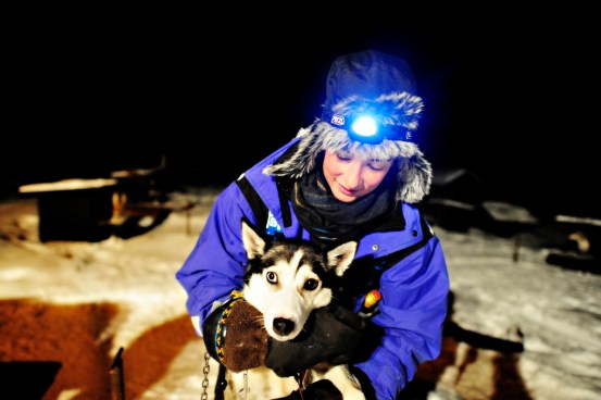 cuddling a husky with two-coloured eyes