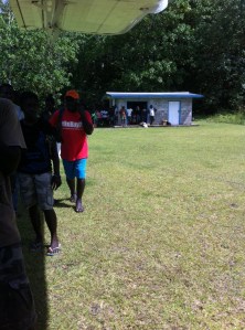 boarding the plane at Balalae